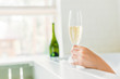 © LIGHTFIELD STUDIOS - close-up partial view of young woman drinking champagne in bathtub