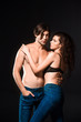 © LIGHTFIELD STUDIOS - portrait of shirtless couple in jeans hugging isolated on black