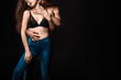 © LIGHTFIELD STUDIOS - partial view of man hugging and kissing girlfriend in black bra and jeans isolated on black