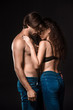 © LIGHTFIELD STUDIOS - side view of sexy shirtless couple hugging isolated on black
