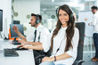 © Bojan - Beautiful smiling woman with headphones looking at camera at office
