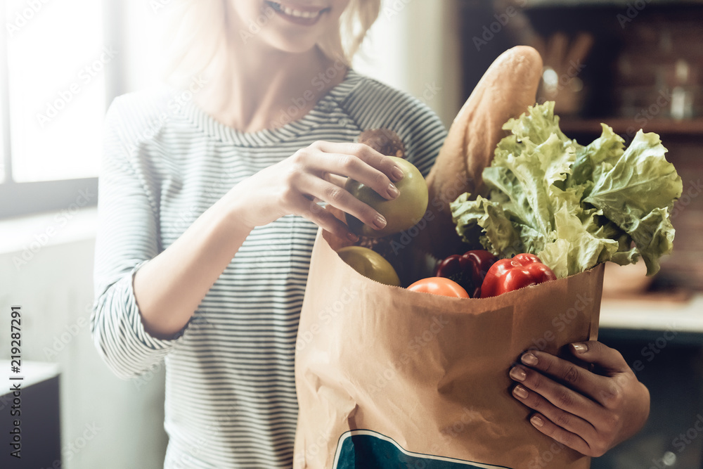Closeup of Smiling Girl holds Bag of Healthy Food - obrazy, fototapety, plakaty 