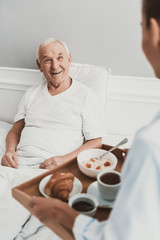 Canvas Print - Nurse giving Lunch to Senior Patient in Hospital