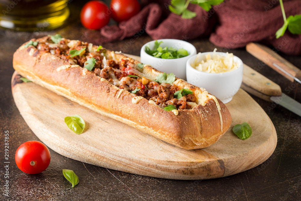 Baguette stuffed with bolognese ragout of minced beef, tomatoes and ...