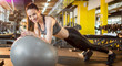 © Bojan - Young sporty girl doing plank exercise on a fitness ball at gym. Panoramic view