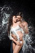 © LIGHTFIELD STUDIOS - portrait of sexy young couple with water splash isolated on black