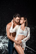 © LIGHTFIELD STUDIOS - portrait of seductive couple swilled with water isolated on black