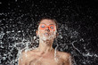 © LIGHTFIELD STUDIOS - portrait of woman in swimming goggles swilled with water isolated on black