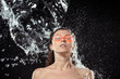 © LIGHTFIELD STUDIOS - portrait of woman in swimming goggles swilled with water isolated on black
