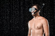© LIGHTFIELD STUDIOS - portrait of shirtless man in swimming mask with snorkel standing under water drops isolated on black