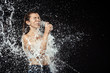 © LIGHTFIELD STUDIOS - side view of woman swilled with water while drinking water from glass isolated on black