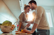 © ivanko80 - Young couple in kitchen preparing lunch