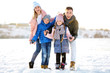 © New Africa - Portrait of happy family outdoors on winter day