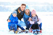© New Africa - Portrait of happy family with sledge outdoors on winter day