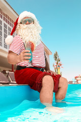 Wall Mural - Authentic Santa Claus with cocktail near pool at resort