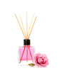Aromatic reed air freshener and rose on white background