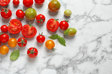 Flat lay composition with juicy tomatoes on marble background