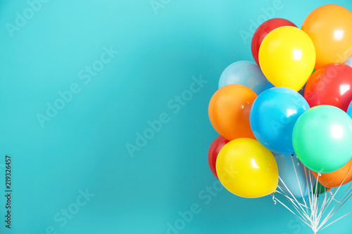 Fotografía Bunch of bright balloons and space for text against color background