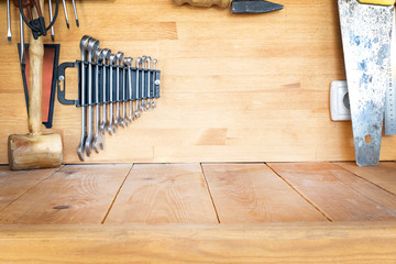 Wooden workbench at workshop. Lot of different tools for diy and repair works. Wood desk for product display. Copyspace. Labour day