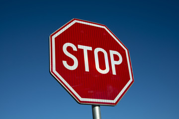 Road traffic sign STOP on blue sky background