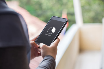 Installing application process on smartphone concept. Woman hand holding phone doing installing update.