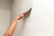 The process of applying the second layer of putty trowel for light plaster walls