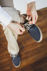 Man wearing eco flax blue shoes. Groom getting ready