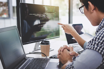 programmers cooperating at developing programming and website working in a software develop company 
