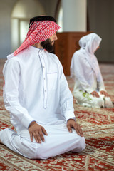 Wall Mural - Muslim man and woman praying in mosque