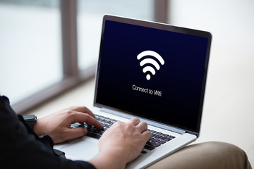 Man waiting for wi-fi connection concept on the laptop / computer at office