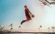© Artur Didyk - Streetball. Basketball player in action on sunset.