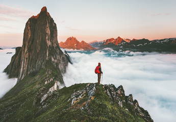 traveler on cliff over clouds exploring sunset segla mountain alone hiking adventure journey outdoor