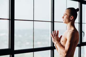 Wall Mural - yoga instructor. fitness trainer. sport and athletic lifestyle. concentrated serene fit toned and muscular male teacher.