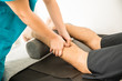 © AntonioDiaz - Physiotherapist Hands Massaging Calf Muscle Of Patient