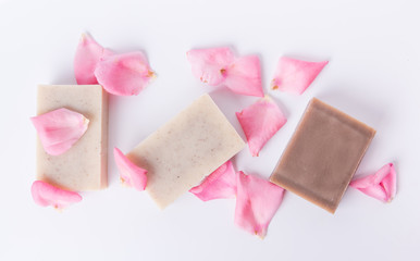 Poster - Top view of handmade soap with flower petals on white background