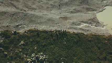 Wall Mural - aerial view hiking group standing on mountain edge. climbing a mountain