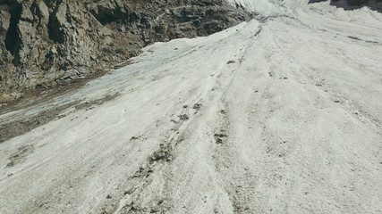 Wall Mural - aerial shooting from flying drone mountain glacier on summer day