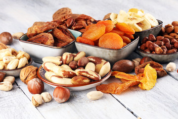 dried fruits and assorted nuts composition on rustic table