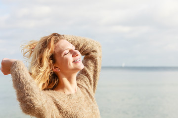 Wall Mural - Happy woman outdoor wearing jumper