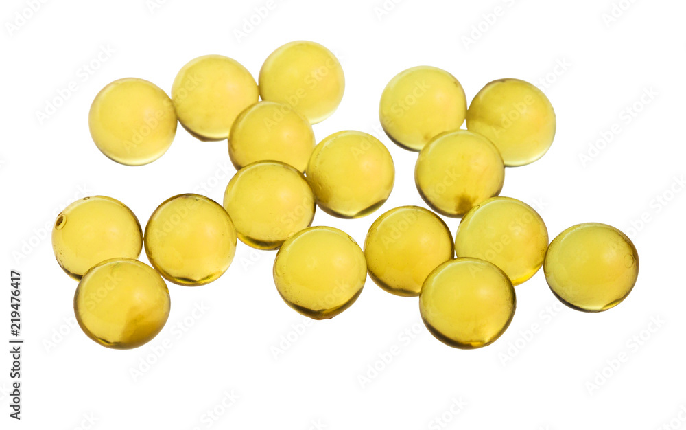 yellow capsules with oil isolated on white