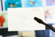 tongs keeps postage stamp with unused back side