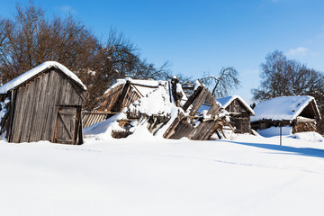 Poster - snow-covered ruined courtyard in village in winter