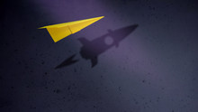 Start-up Company And Motivation In Business Concept. Paper Planes Flying With Shadow Of Rocket By The Wall
