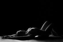 Silhouette Of A Woman Lying On The Floor In Her Underwear Black And White Photo