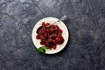 Wall Mural - Dried sweet strawberry on a black background. Top view of a candied berries.