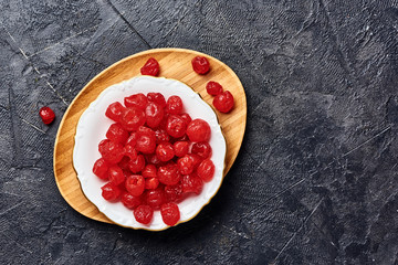 Wall Mural - Candied dried cherry on plate. Top view of berries.