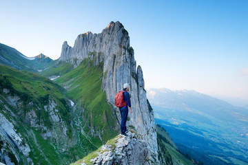 Tourist on the high rocks background. Sport and active life concept. Adventure and travel in the mountain region in the Switzerland mountains.