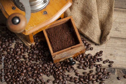 Kaffeebohnen mit Kaffeetasse und Kaffeemühle auf Holzbrett – kaufen Sie