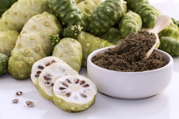 Wall Mural - Noni fruit or Morinda Citrifolia with noni slice and noni powder for health on the white background.