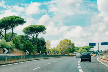 Canvas Print - Cars and empty blue traffic signs in road in Italy